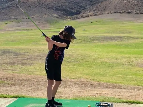 Kind beim Golfspielen