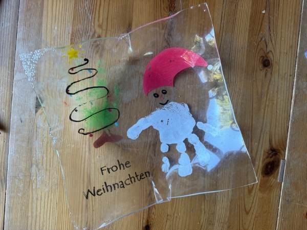 Bunte Weihnachtsdekoration aus Glas mit Schneemannmotiv, Weihnachtsgruß und festlicher Gestaltung, ideal für festliche Stimmung und Dekoration im Winter.
