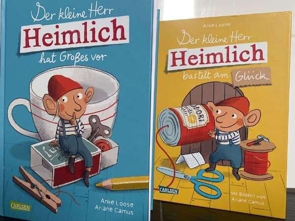 Buchcover von "Der kleine Herr Heimlich" mit Kindern in kreativen Spielszenen, ideal für Leseförderung bei Kindern, Familienbuch, Kinderbuch, Vorlesen, Geschichten, Eltern, Kinderliteratur.