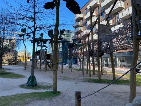 Kinder play area in Berlin with climbing structures and sandy surface, ideal for outdoor recreation and family fun.