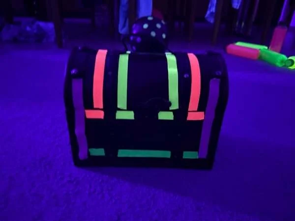 Schatzkiste mit Textilband leuchtend im UV-Licht