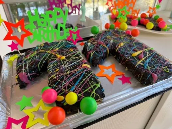 Bunte Schokoladenkuchen mit Streuseln und Knallbonbons für Kindergeburtstag.