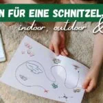 Beitragsbild mit dem Titel "20+ Schnitzeljagd Ideen - indoor, outdoor & digital" mit einer Schatzkarte, die von Kinderhänden gehalten wird auf einem Boden liegend